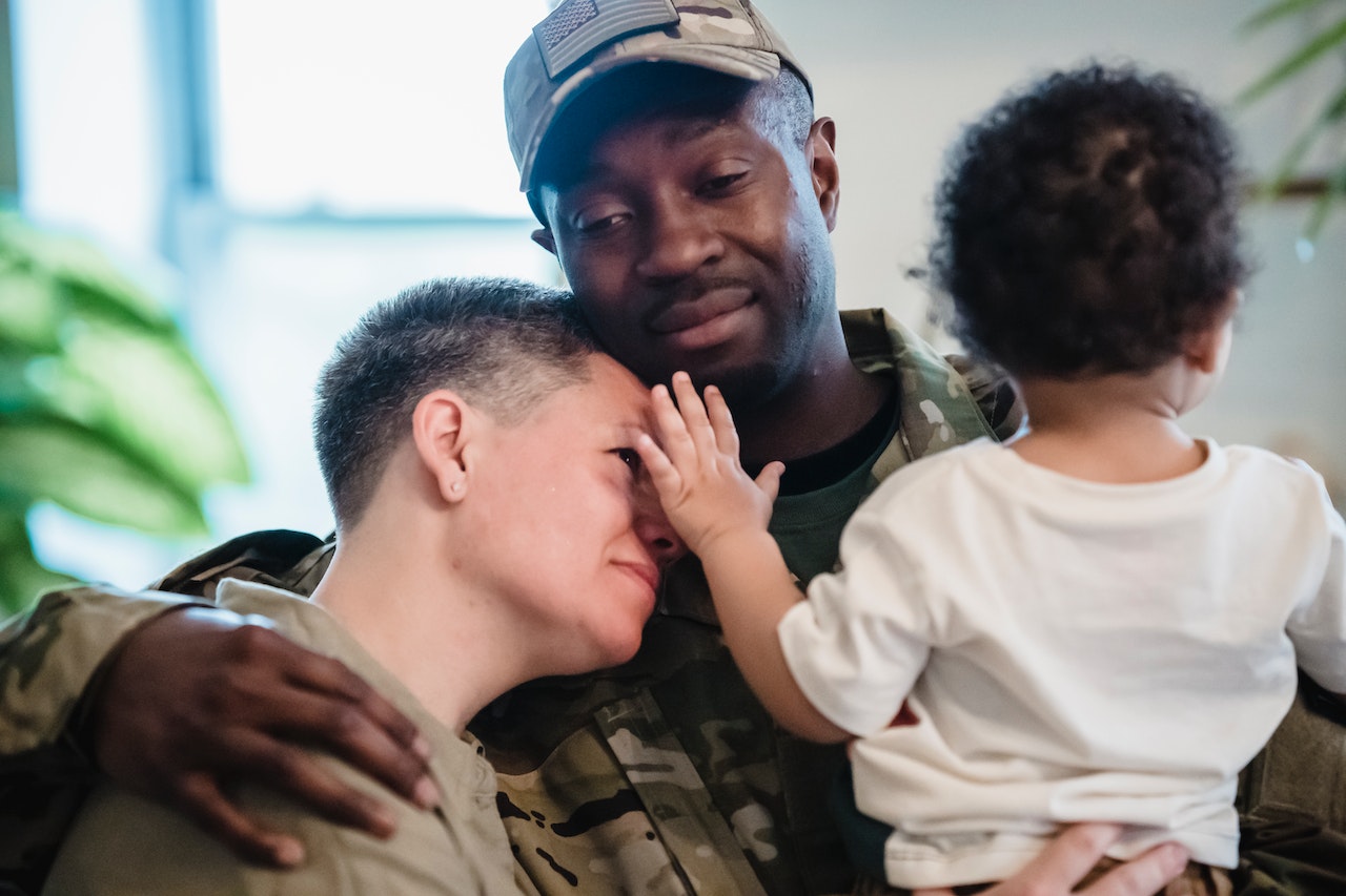 An Army Man Embracing his Family | Veteran Car Donations
