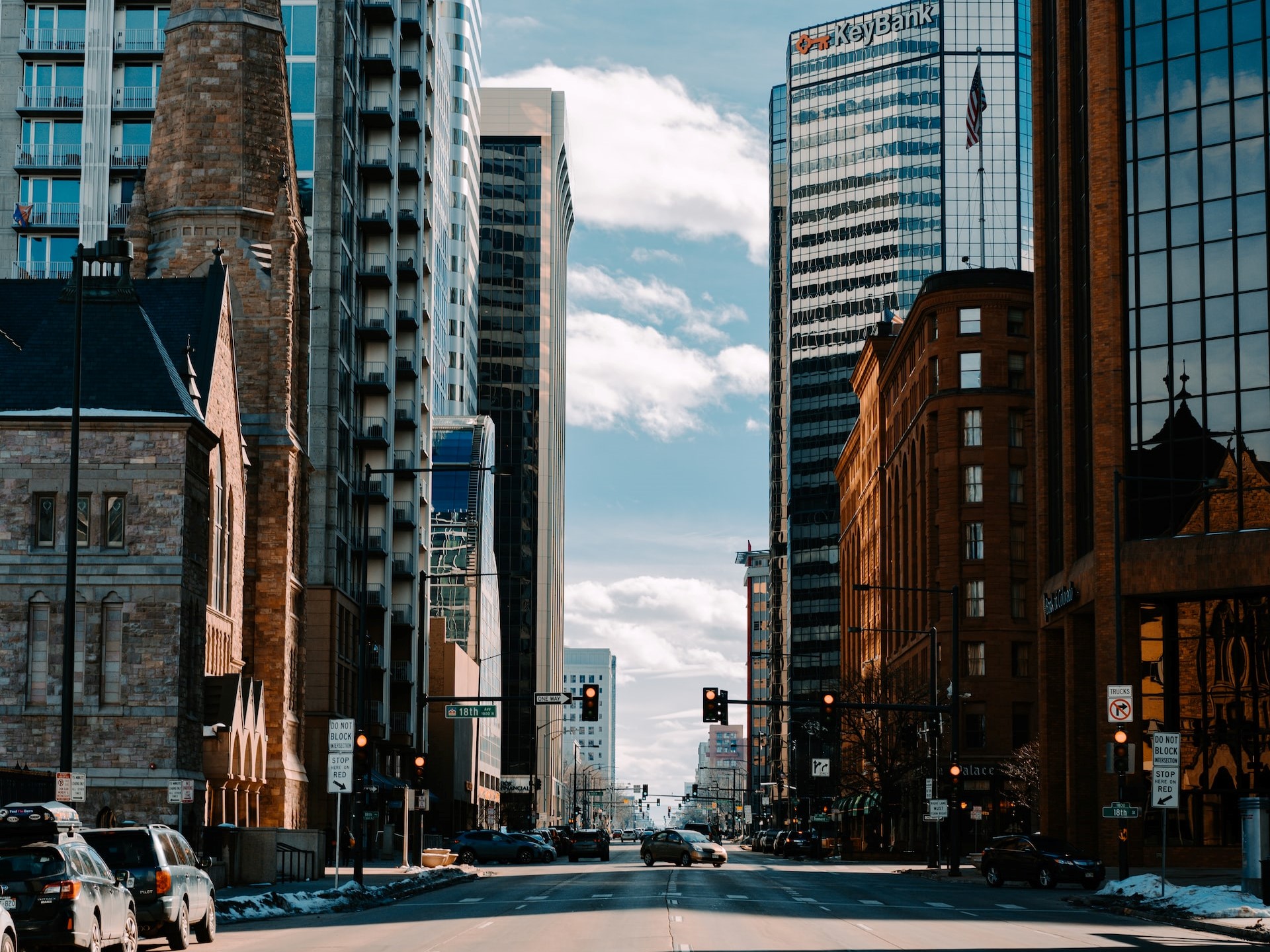 cars on road between high rise buildings during daytime photo | Veteran Car Donations