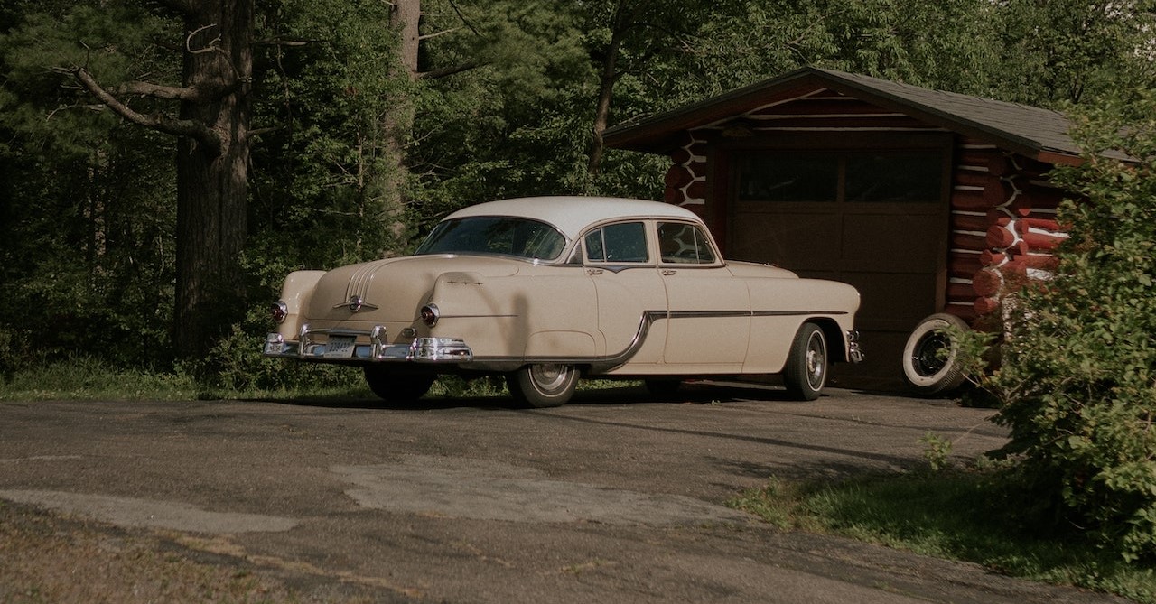 Vintage Car Parked by a Garage | Veteran Car Donations
