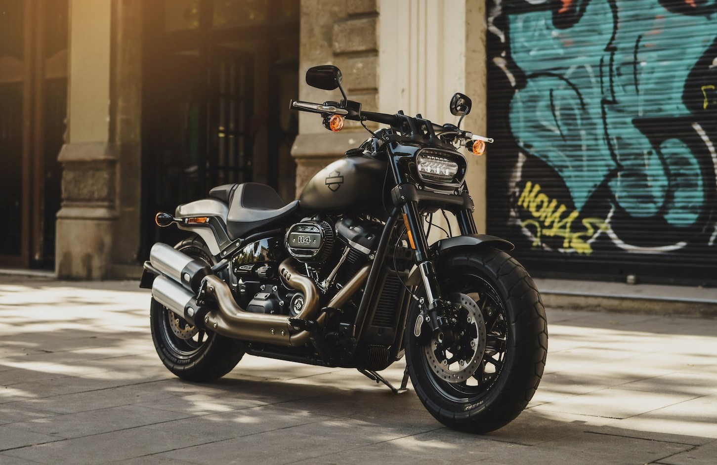 black motorcycle near wall with grafitti | Veteran Car Donations