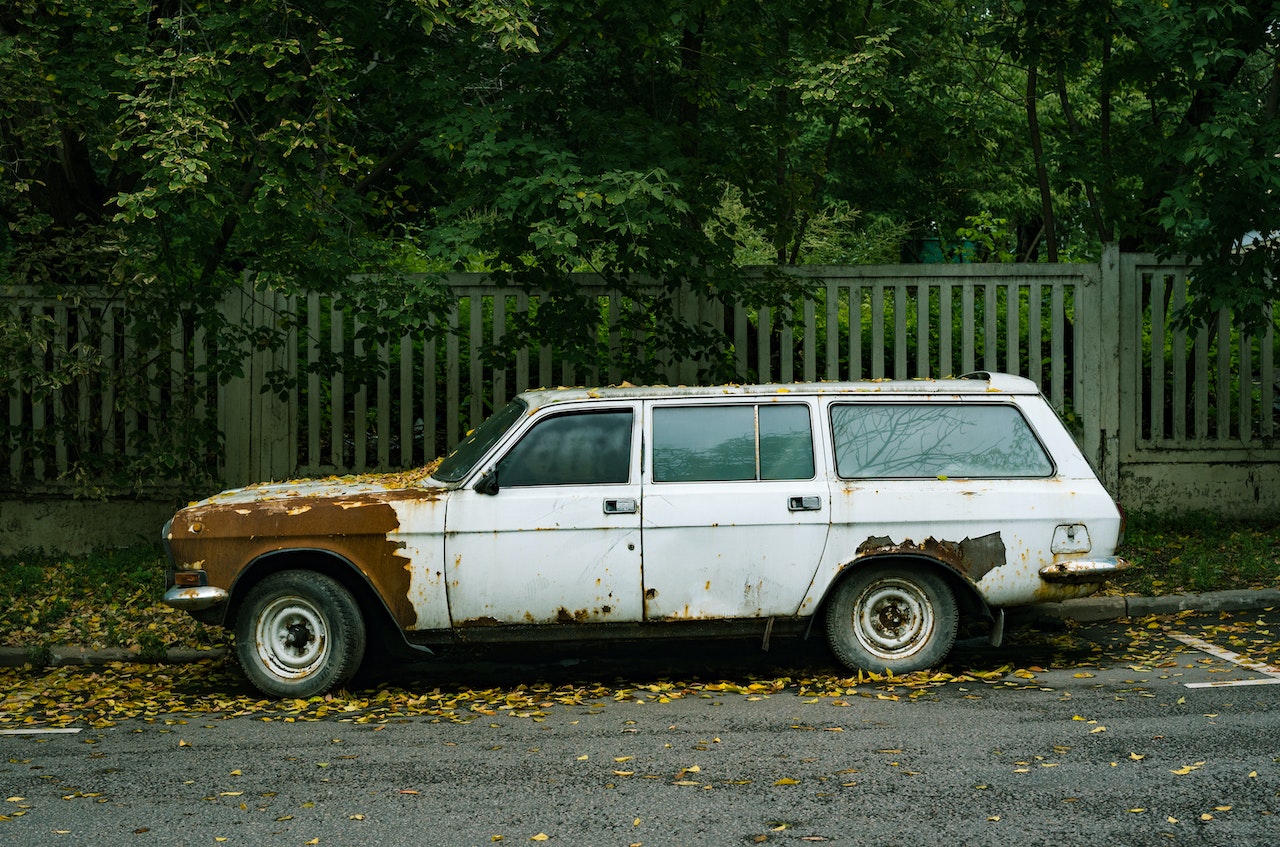 Junked White Station Wagon Parked on the Roadside | Veteran Car Donations
