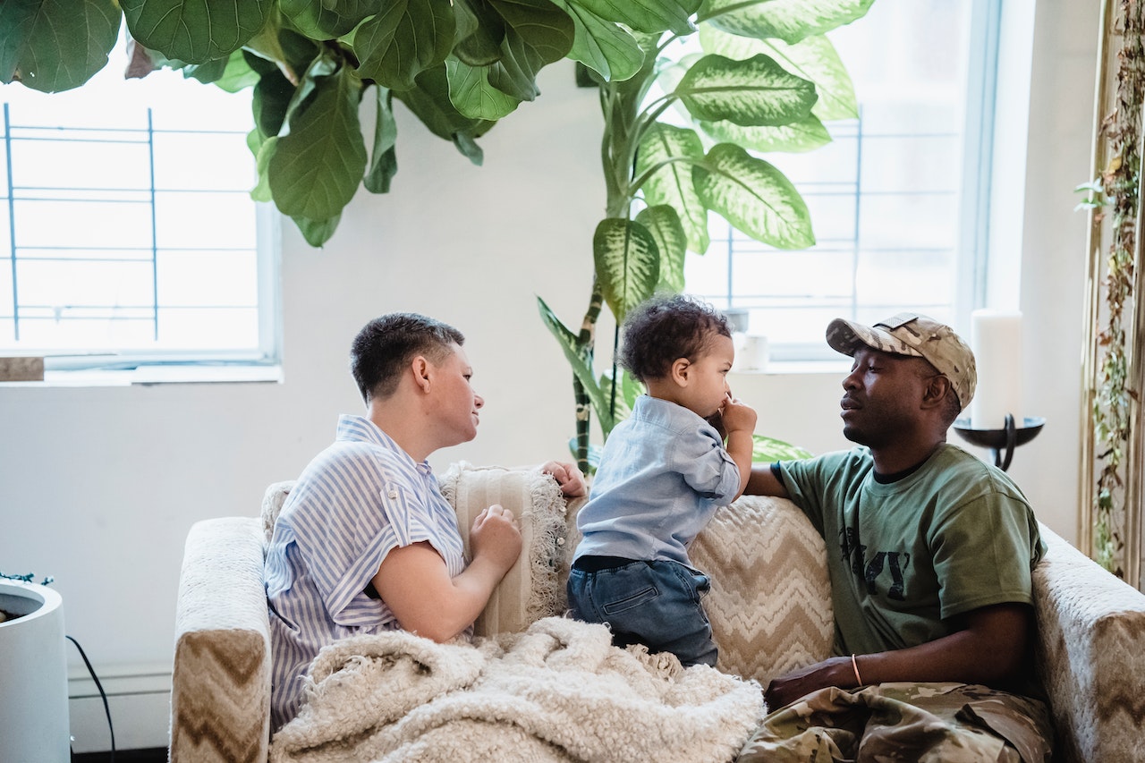 Beautiful Family Sitting on a Couch | Veteran Car Donations
