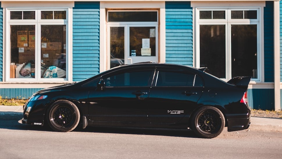 Black car parked near store | Veteran Car Donations