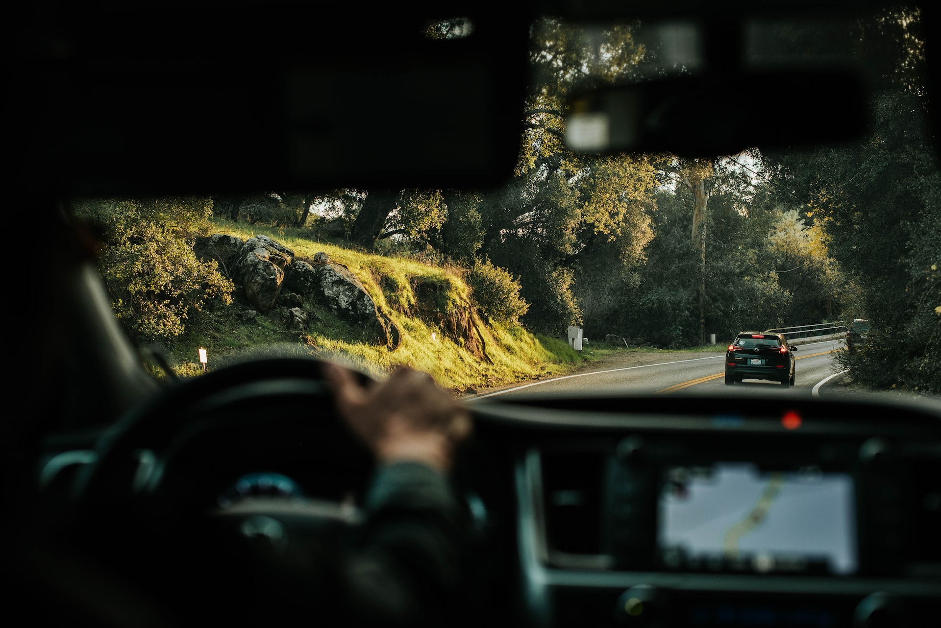 A sunlit hillside shot over the car dashboard. | Veteran Car Donations