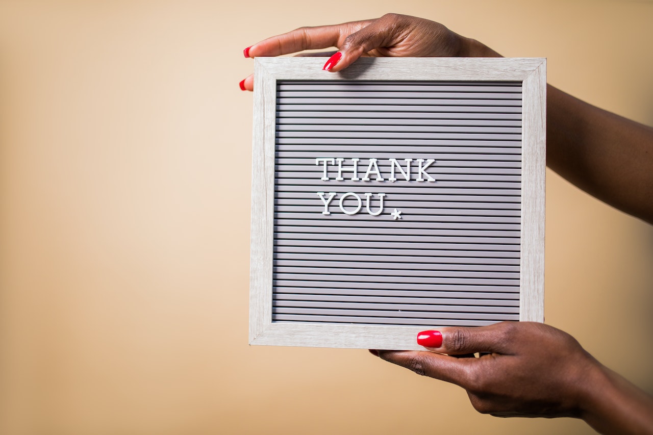 A Person Holding a Gray Thank You Signage | Veteran Car Donations