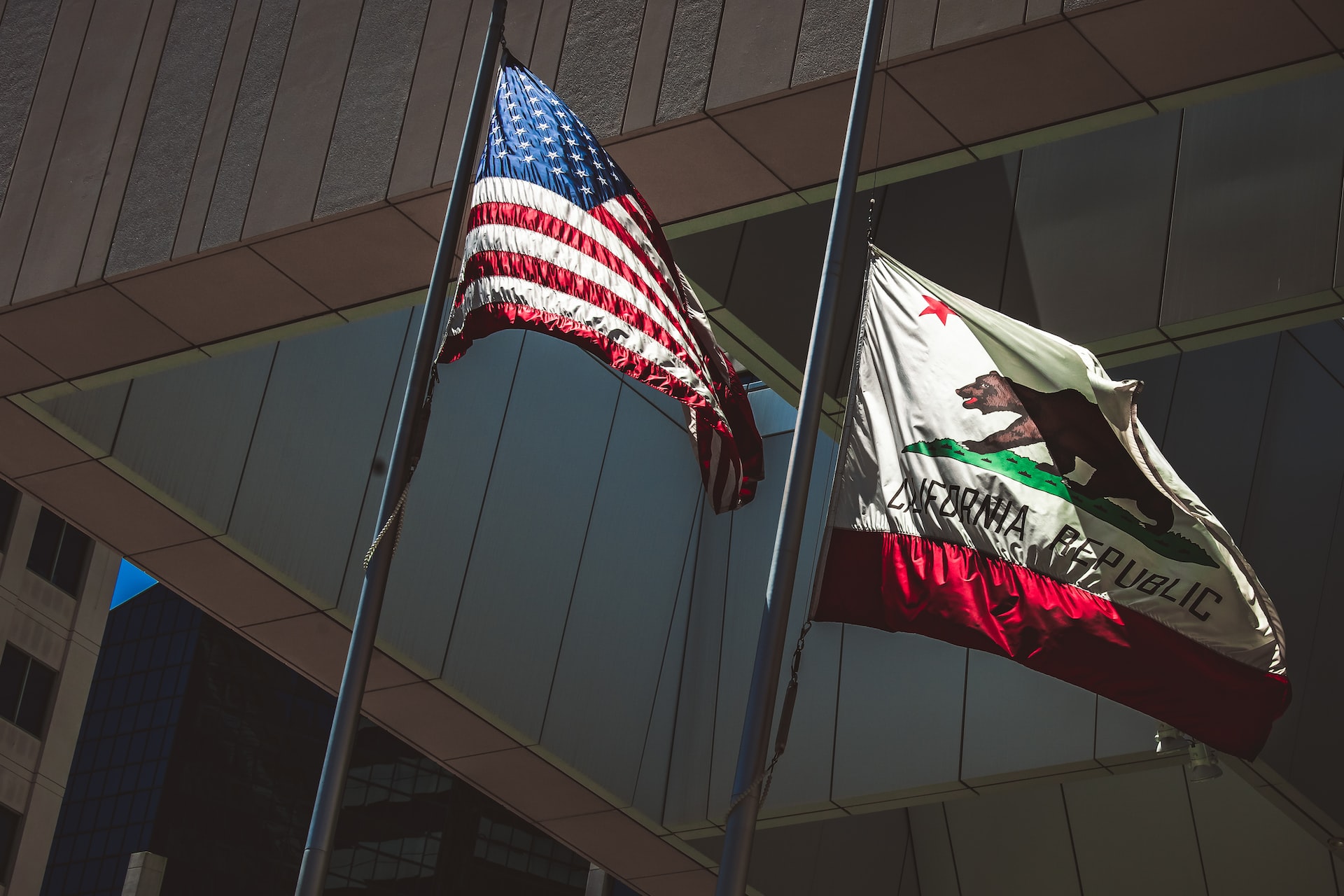 American and California Flags outside of a government building Downtown San Diego on a sunny morning