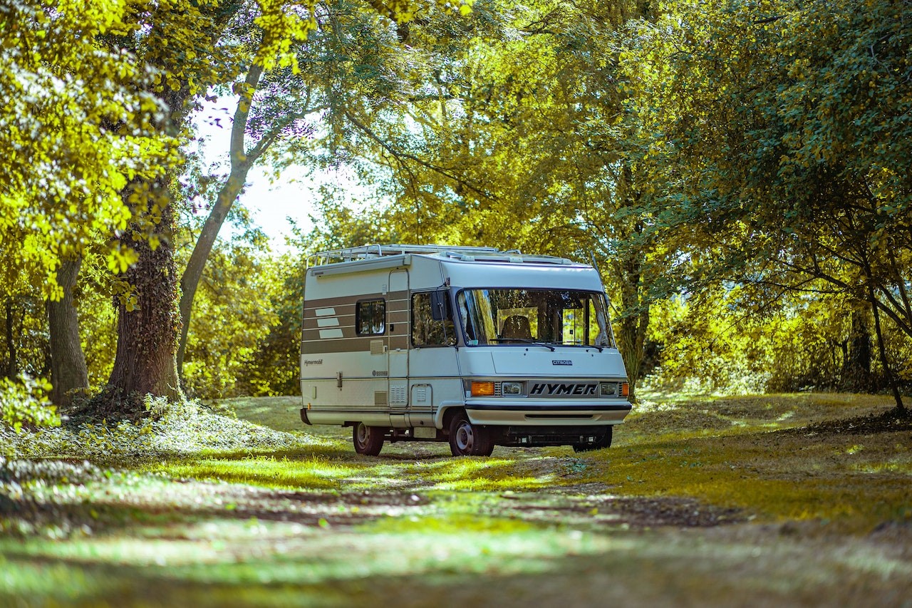 Camper Van Surrounded by Trees | Veteran Car Donations