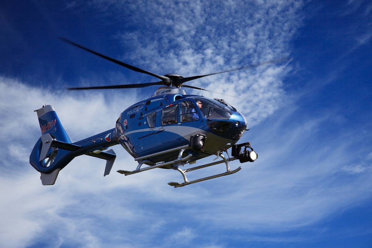 Person Riding Blue Helicopter | Veteran Car Donations