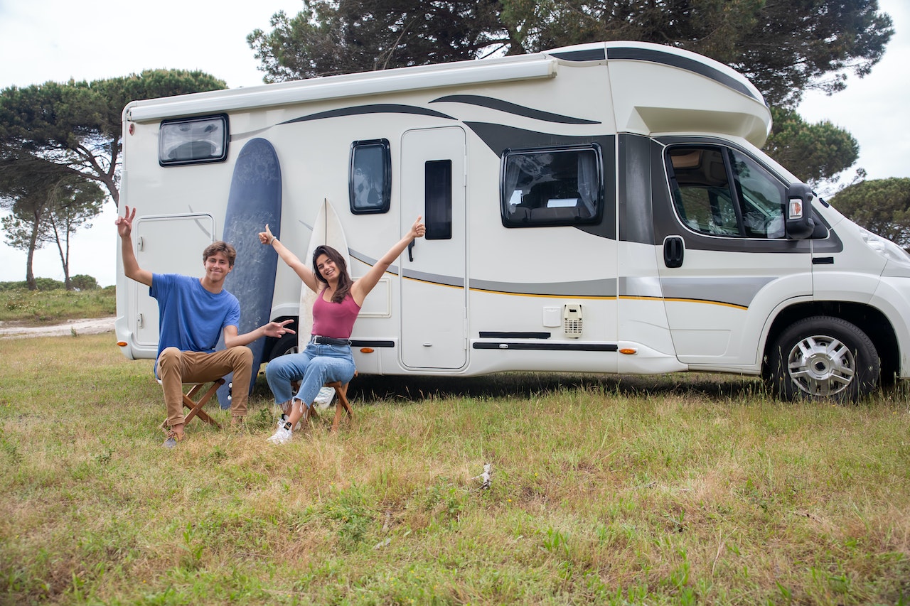 Persons Sitting Beside White RV | Veteran Car Donations