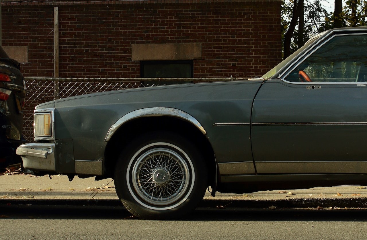 Photo of a Vintage Car Near a Brick Building | Veteran Car Donations
