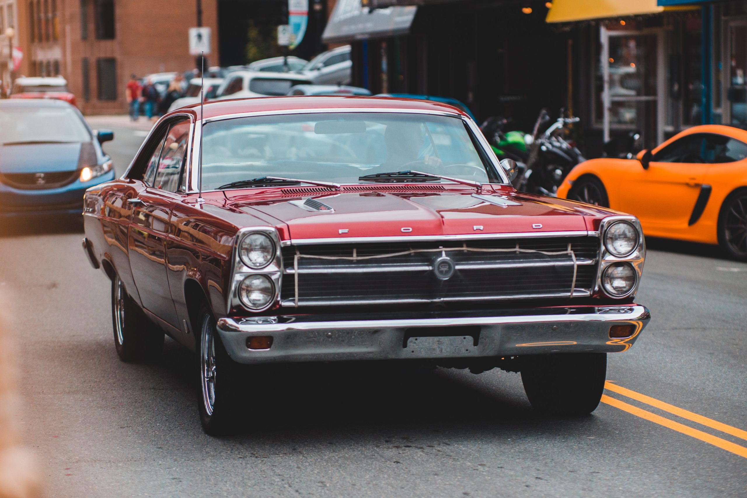 Unrecognizable driver in aged car on asphalt road in town | Veteran Car Donation
