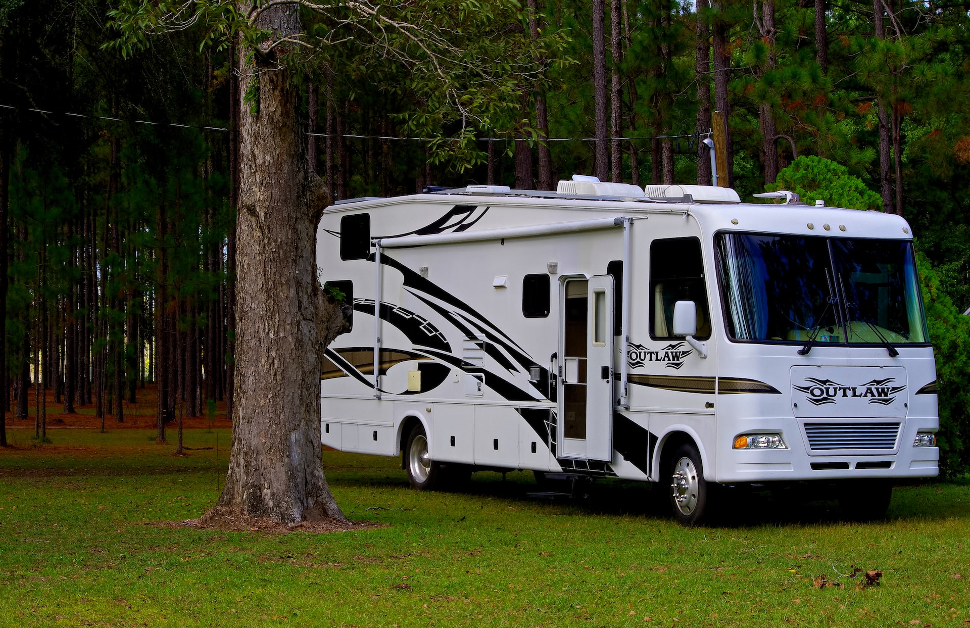 White Class A motorhome parked near trees | Veteran Car Donations