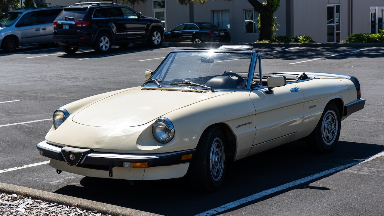 White Convertible Vintage Car at a Parking Lot | Veteran Car Donations