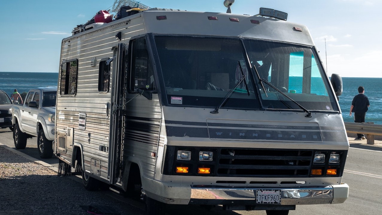 White RV Trailer on Gray Asphalt Road | Veteran Car Donations