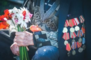 Old Veteran Holding some Flowers - VeteranCarDonations.org
