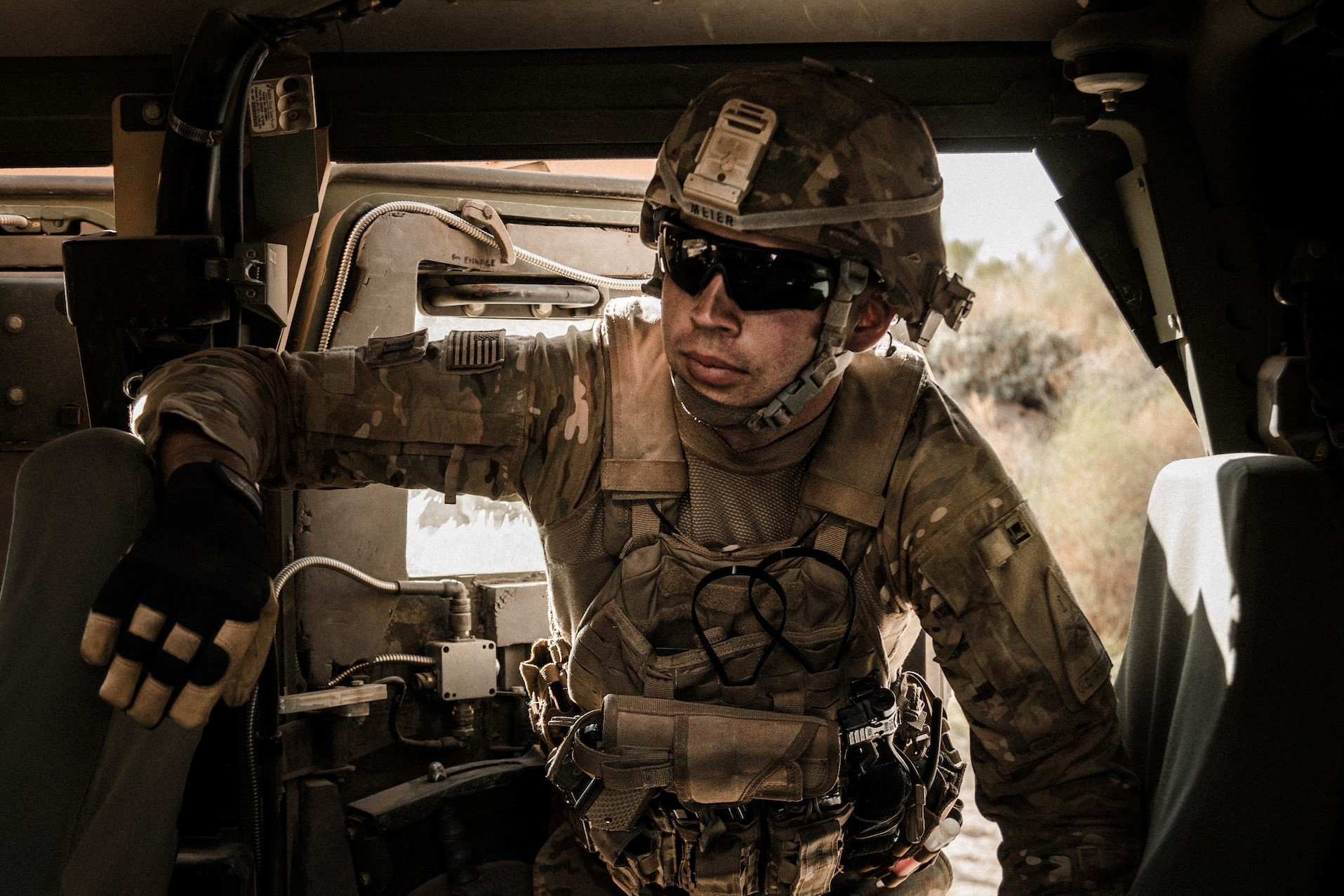 man in brown and black camouflage uniform on black car seat | Veteran Car Donations