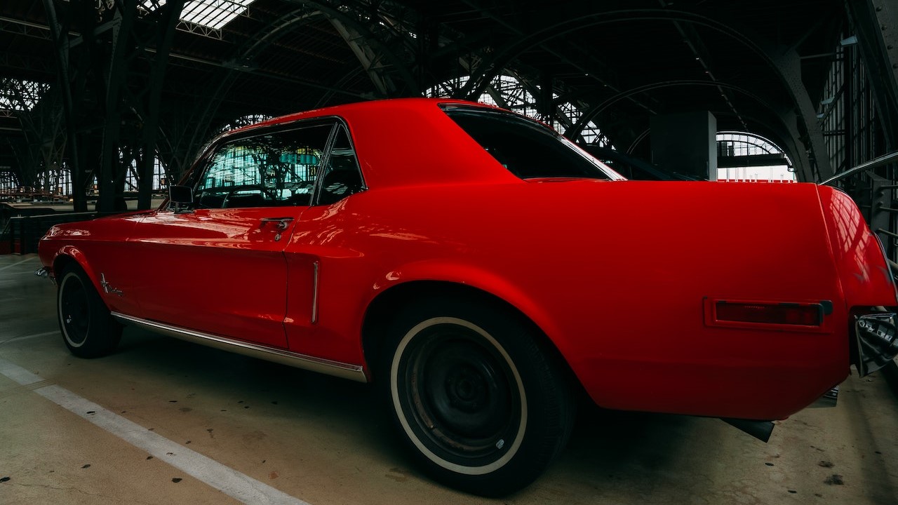 A Red Vintage Car Parked inside the Garage | Veteran Car Donations