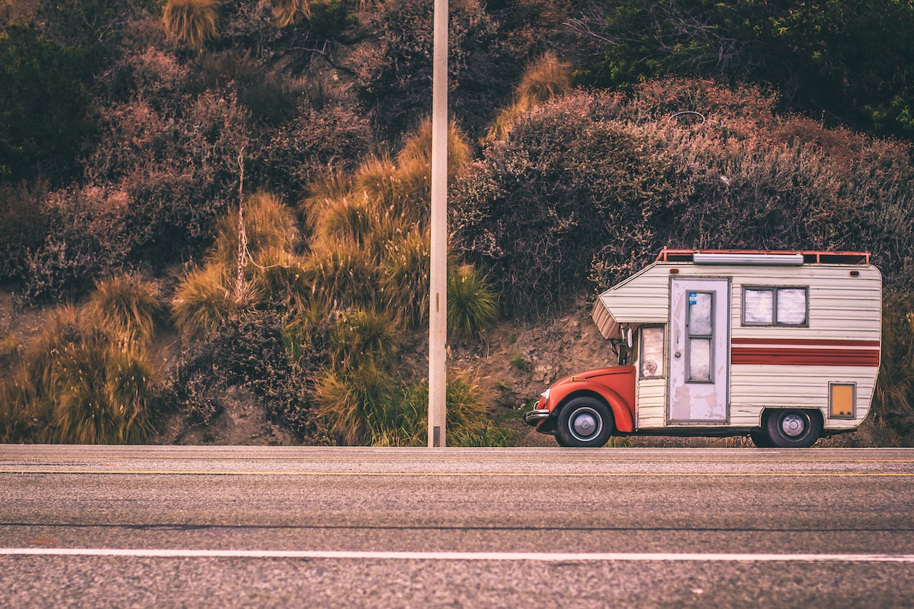 A Red and White Campervan on Road | Veteran Car Donations