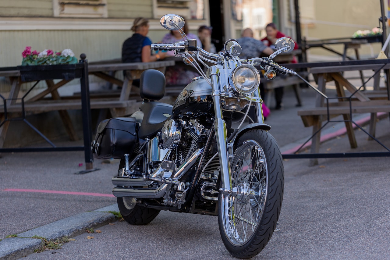 Black and Silver Motorcycle Parked on Sidewalk | Veteran Car Donations