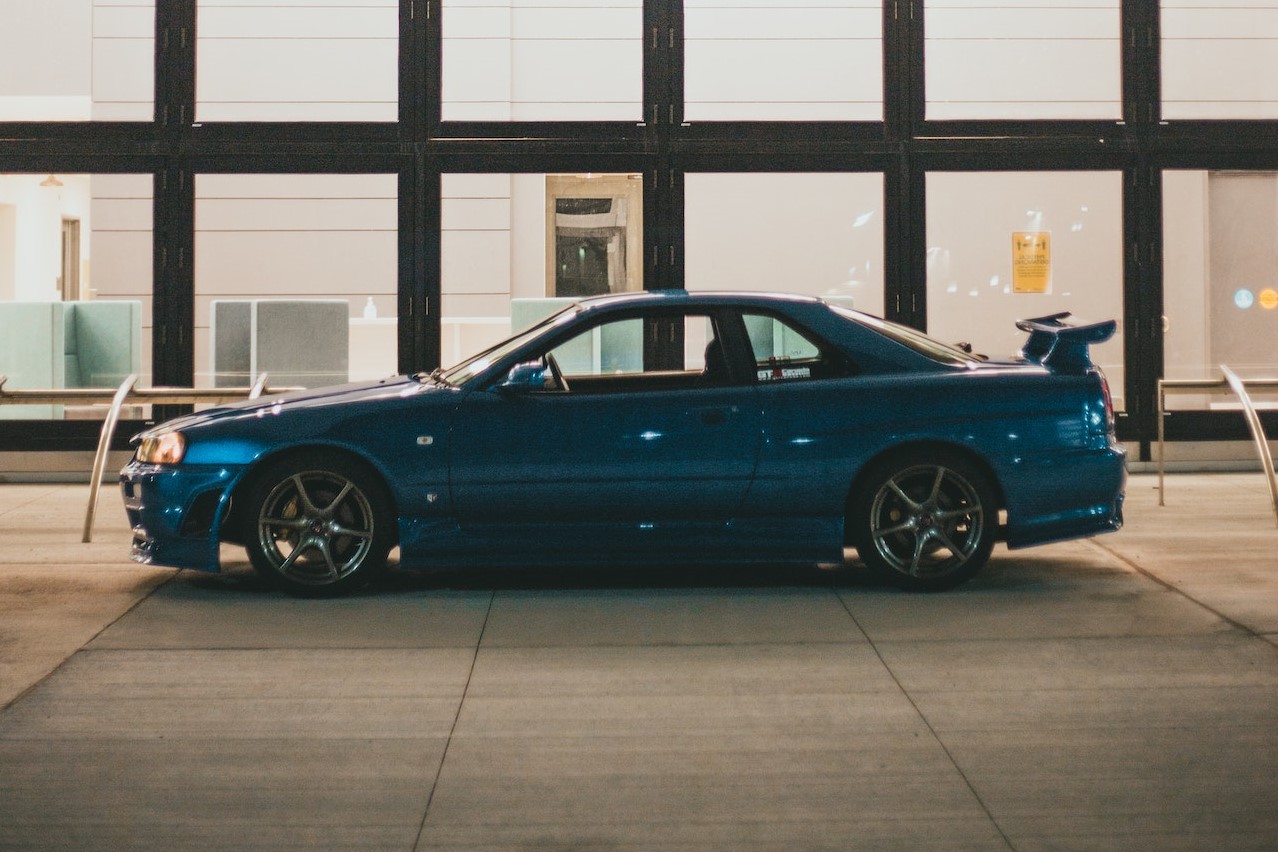 Blue Car Parked Beside Glass Building | Veteran Car Donations