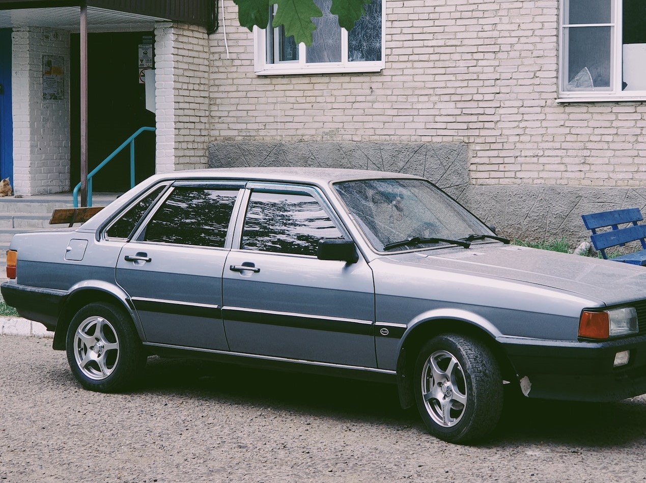 Gray Audi Parked Beside Brick Building | Veteran Car Donations