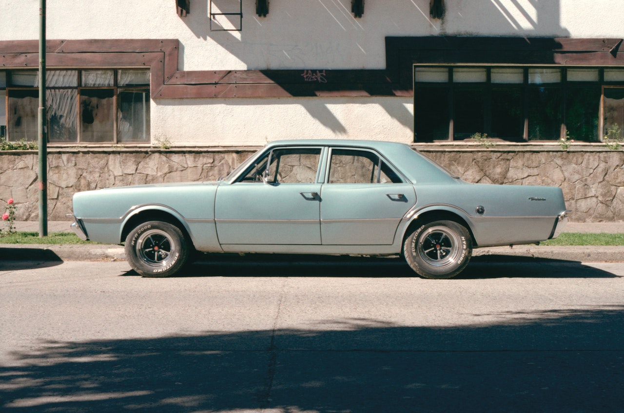 Old Sedan parked on road | Veteran Car Donations