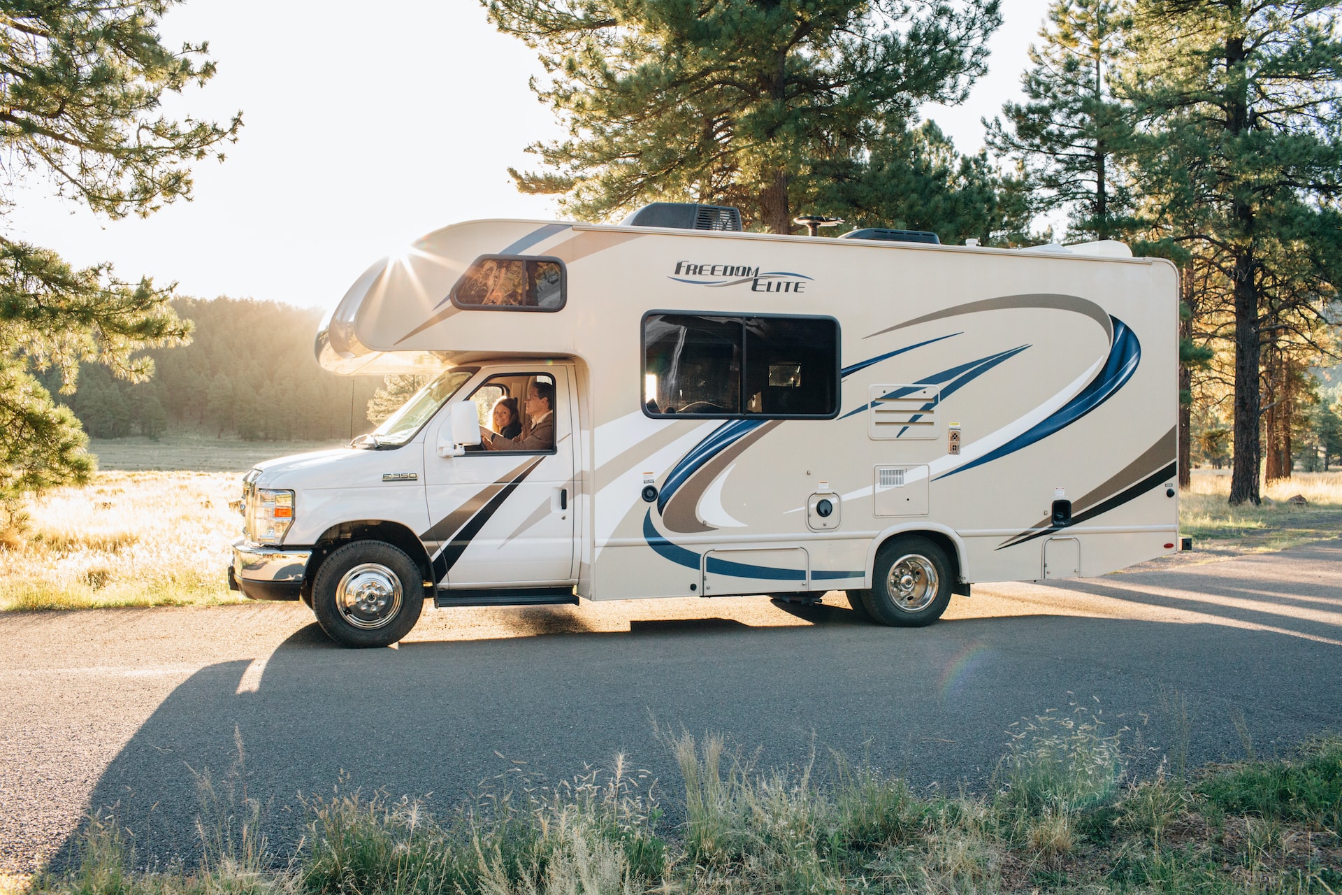 People Riding White Rv under Bright Sky | Veteran Car Donations