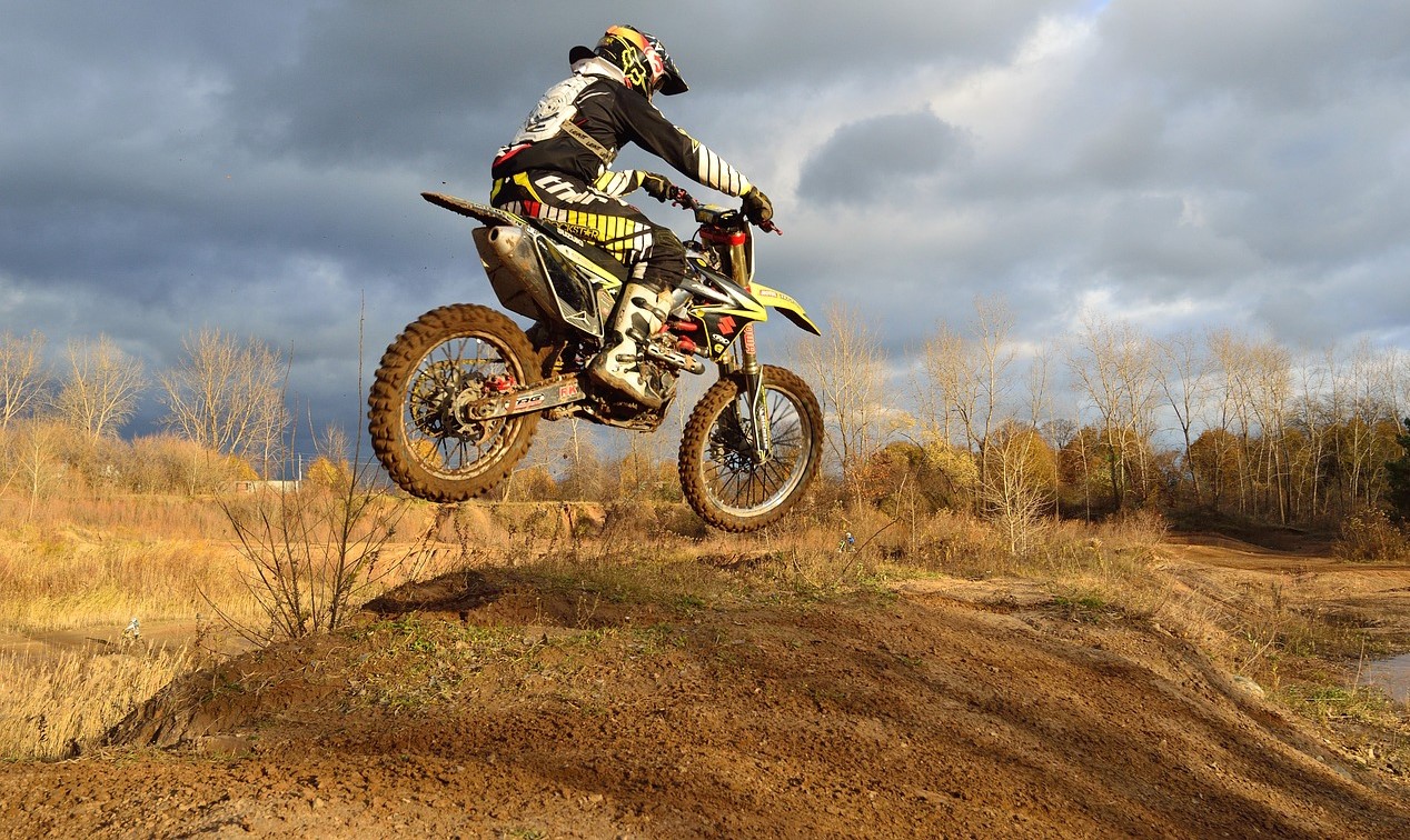 Person Riding Dirt Bike Jumping | Veteran Car Donations