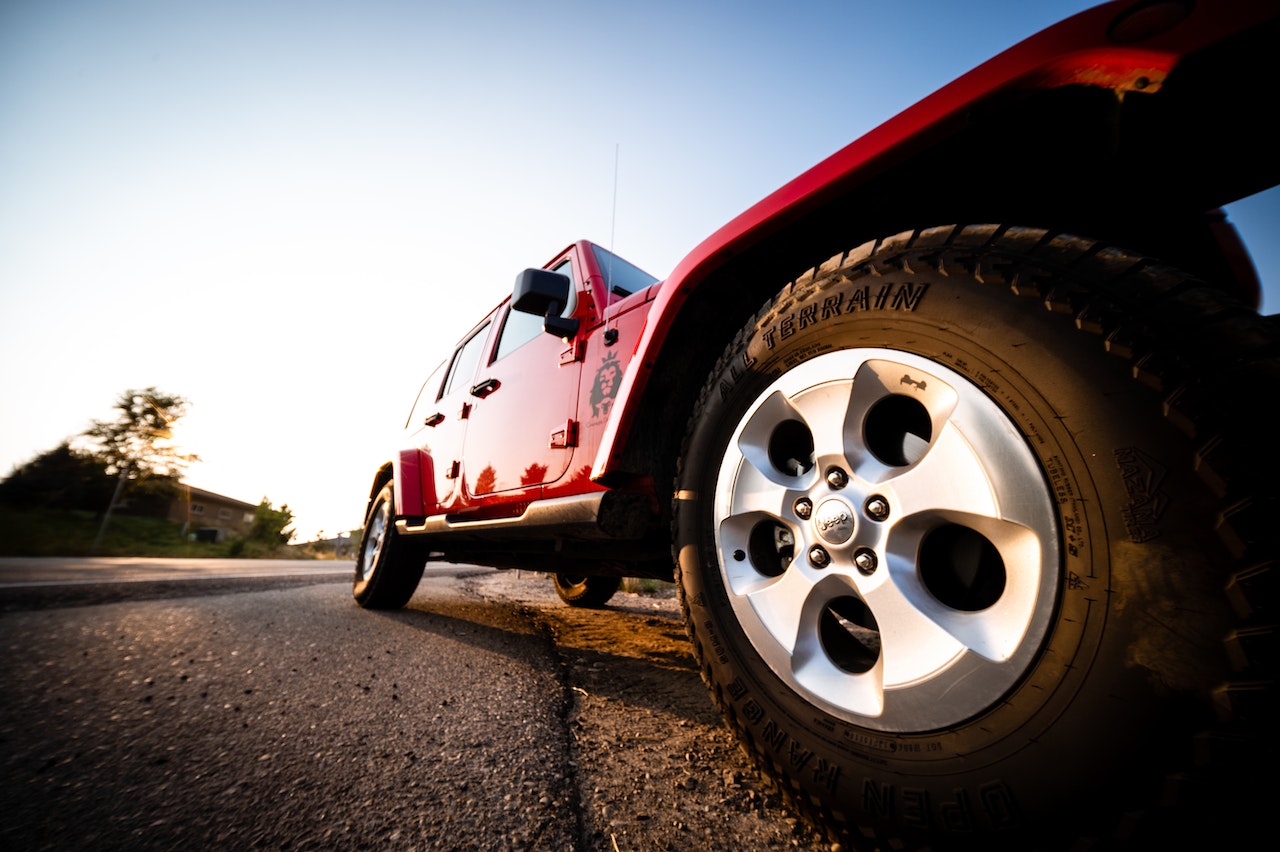 Red all terrain vehicle on road | Veteran Car Donations