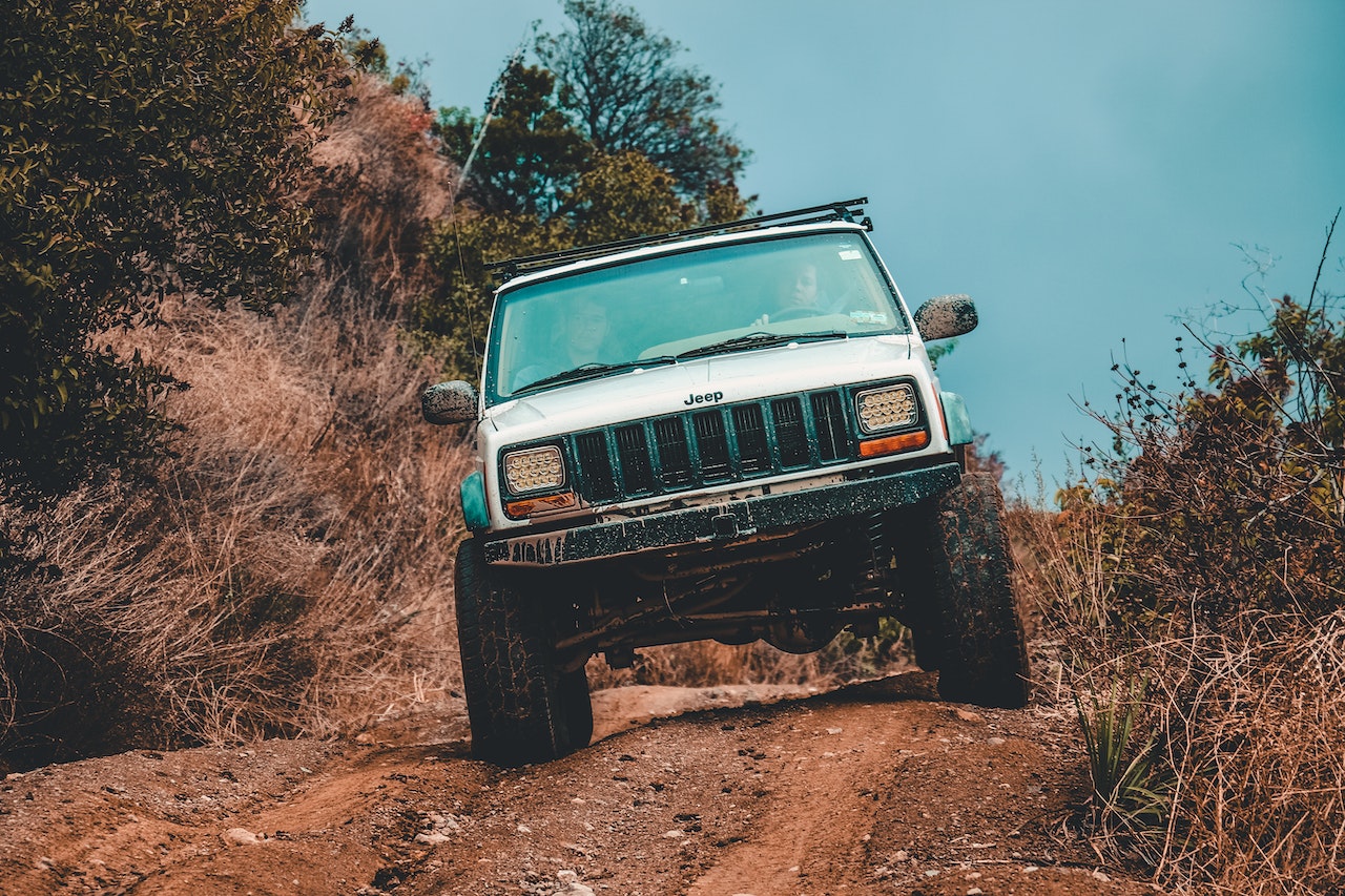 White Jeep Suv Cruising Down the Road | Veteran Car Donations