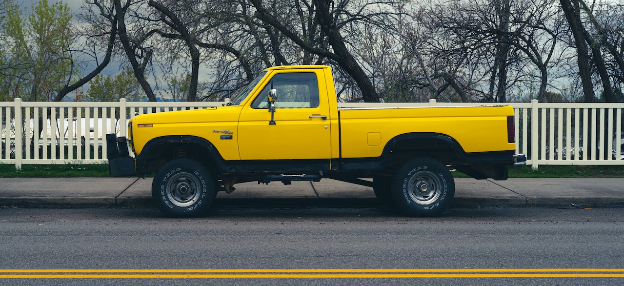 Yellow Truck Parked on the Road | Veteran Car Donations