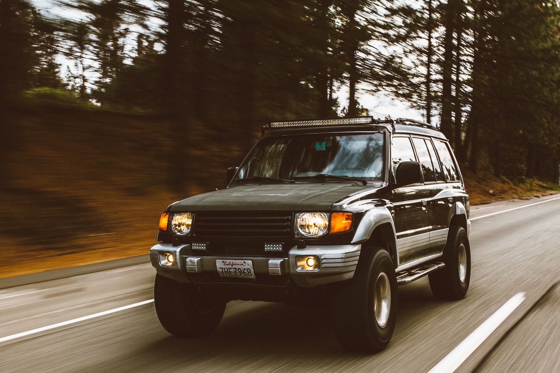 timelapse photography of green SUV on road photo | Veteran Car Donations