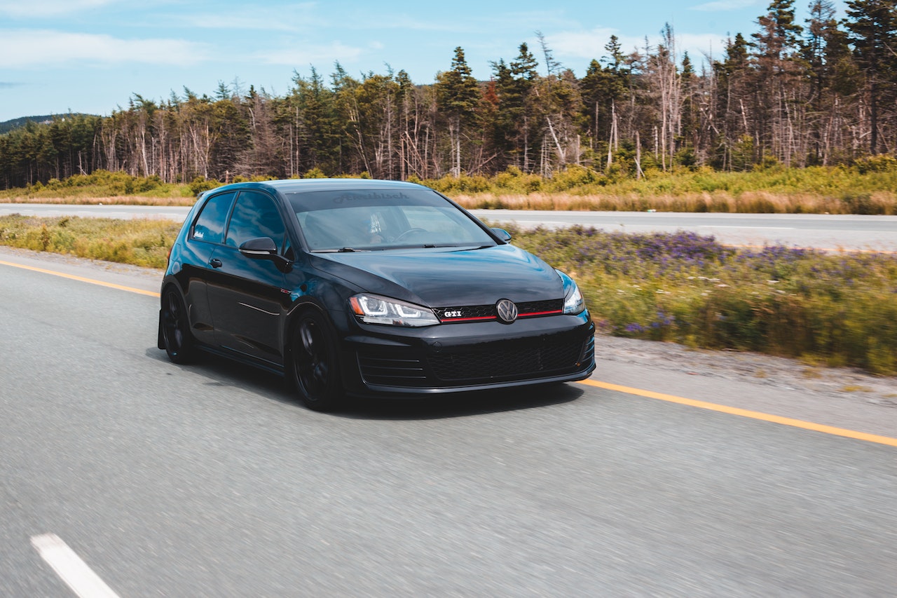 Black sports car on highway | Veteran Car Donations