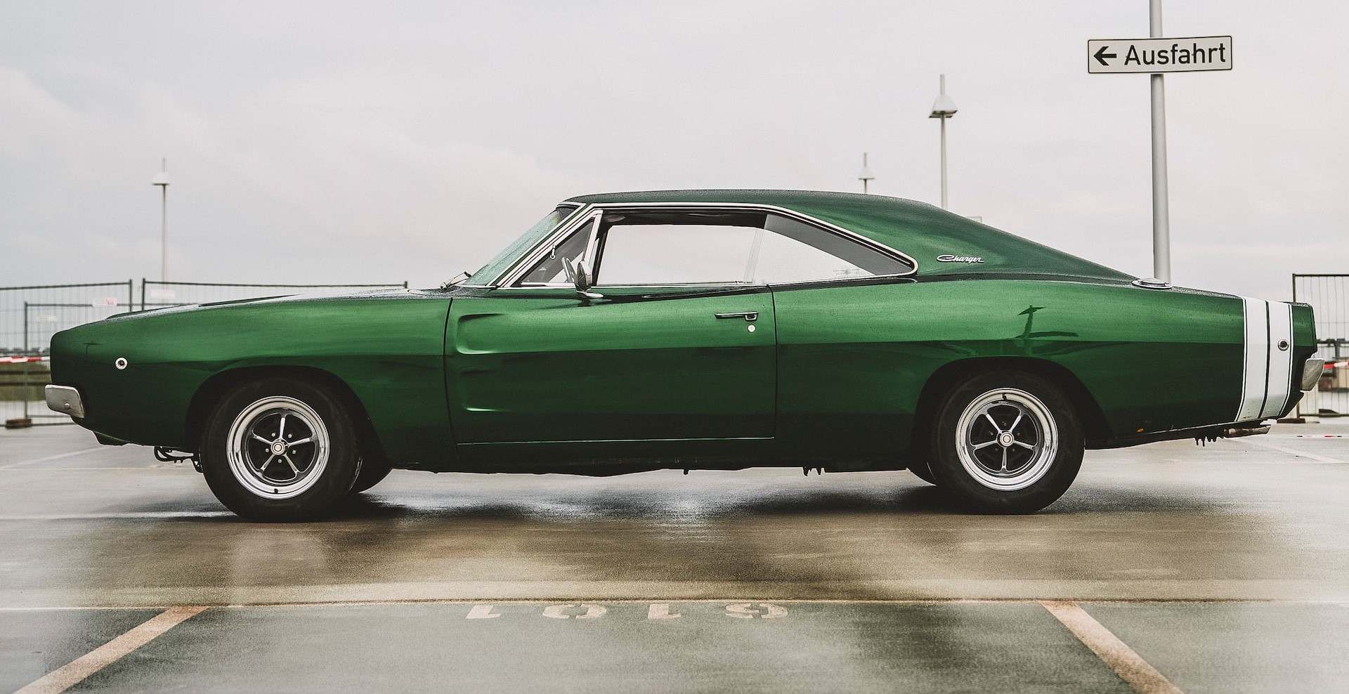 Green Coupe Parked on a empty space | Veteran Car Donations