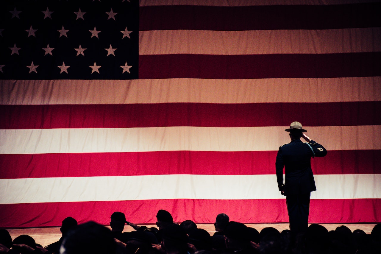 Man Standing on Stage | Veteran Car Donations