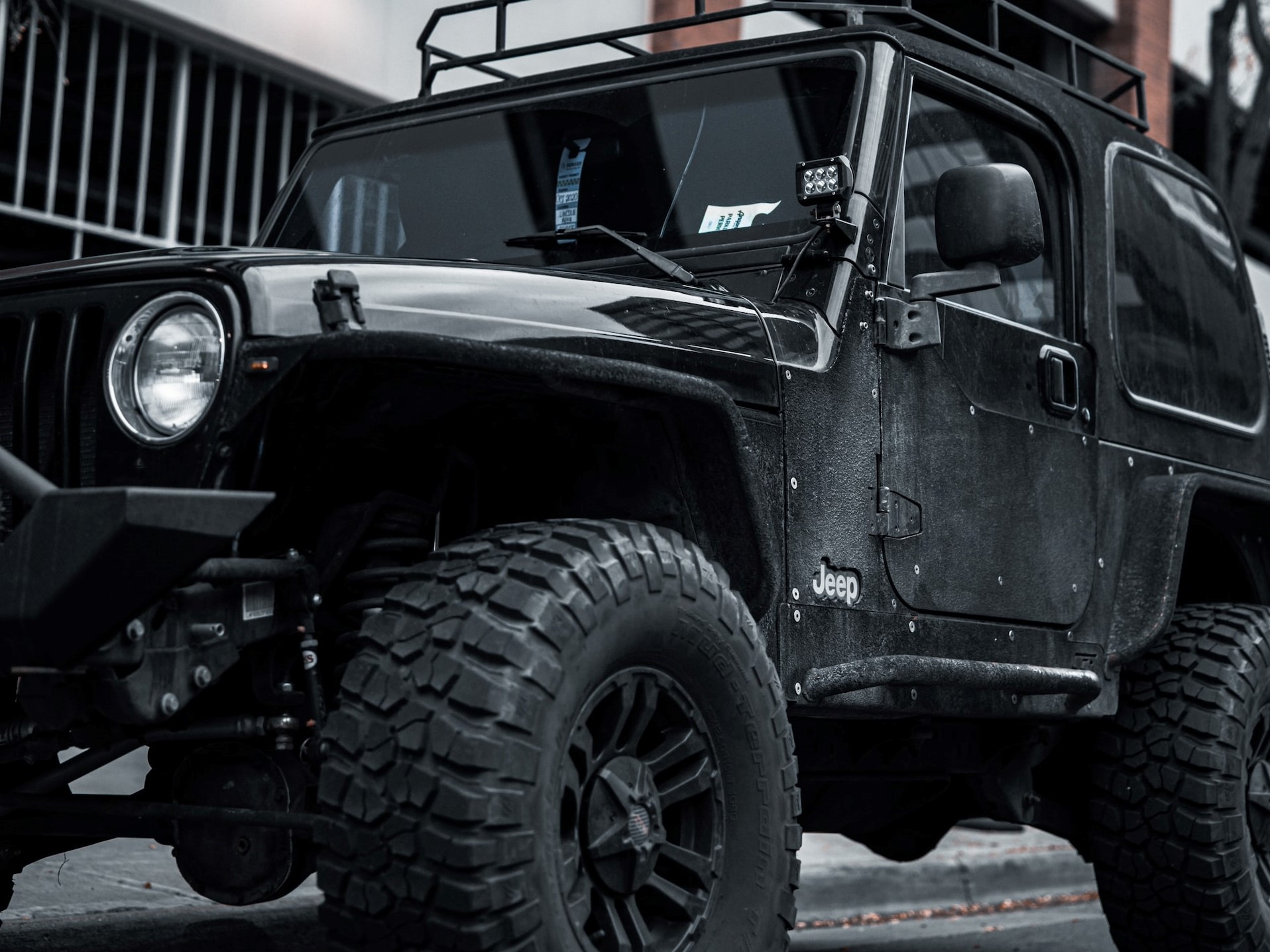 black jeep wrangler parked near white building | Veteran Car Donations