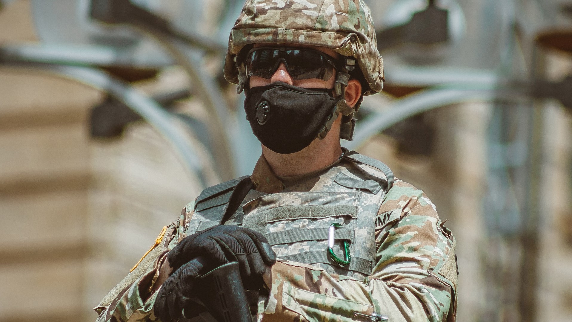 man in brown and black camouflage uniform holding rifle photo | Veteran Car Donations