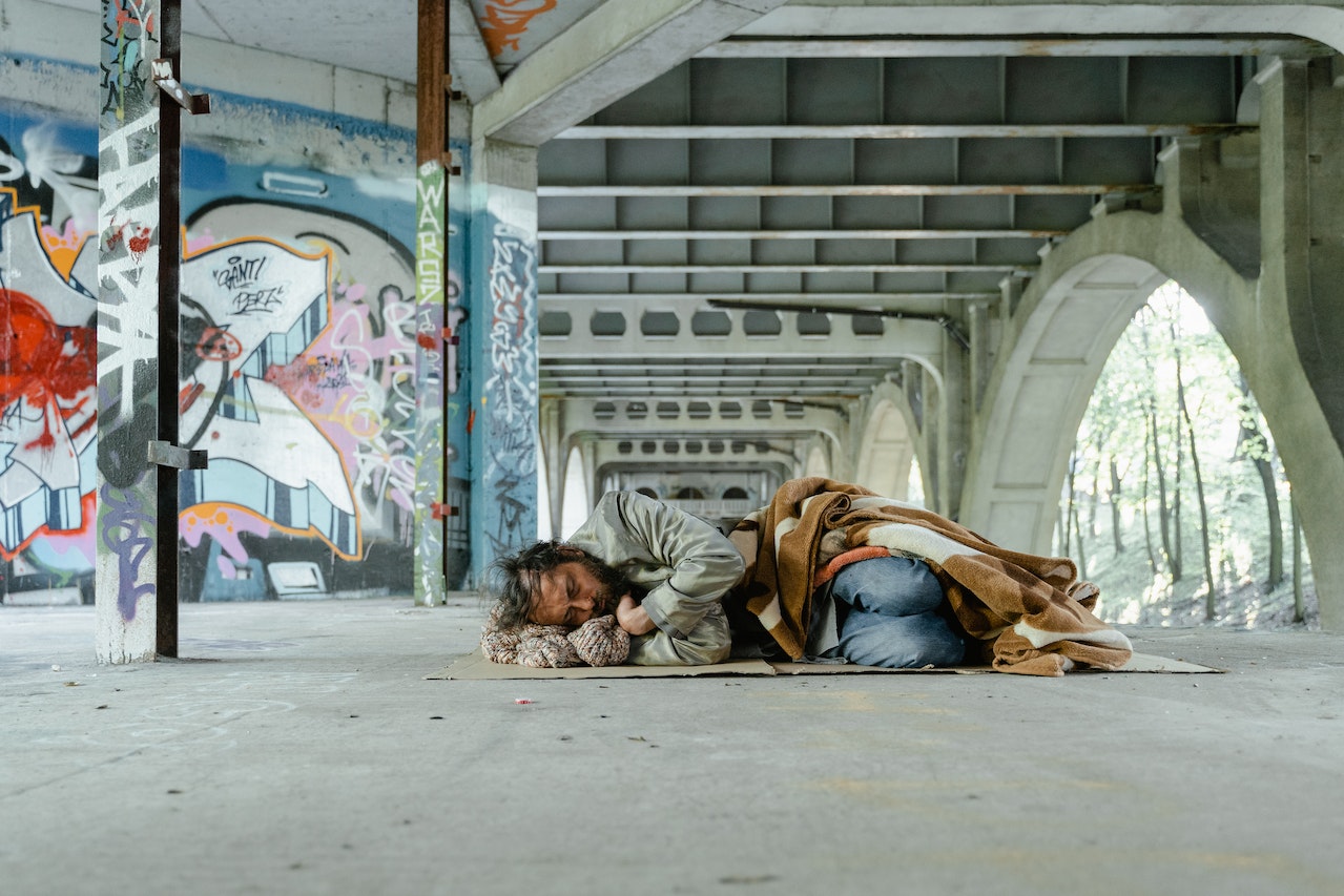 A Man Sleeping on a Cardboard | Veteran Car Donations
