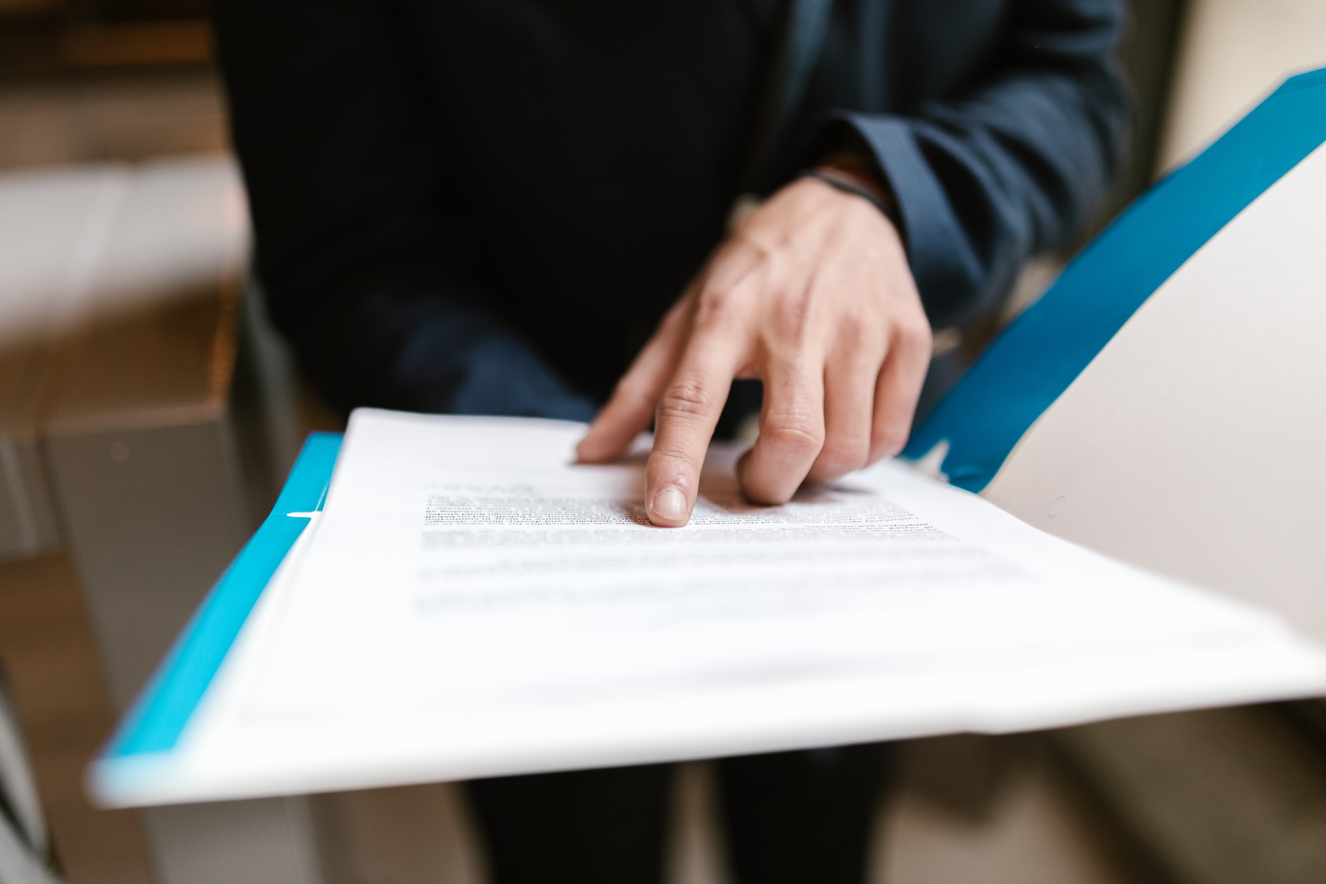 Close Up Photo of Person Pointing on White Paper | Veteran Car Donations