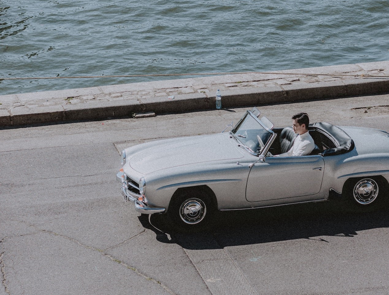 Man Driving silver car | Veteran Car Donations