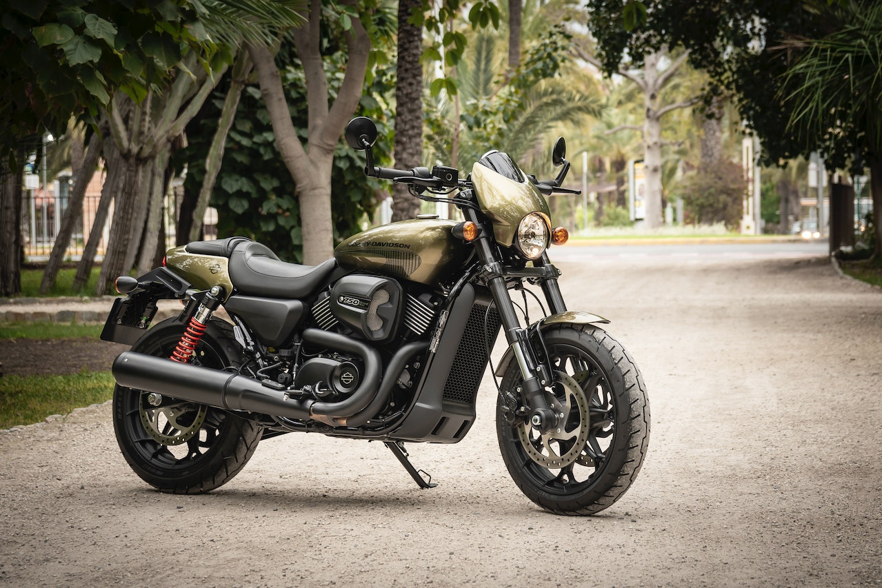 Photo of Black and Brown Harley Davidson 750 Parked on Gravel Road | Veteran Car Donations