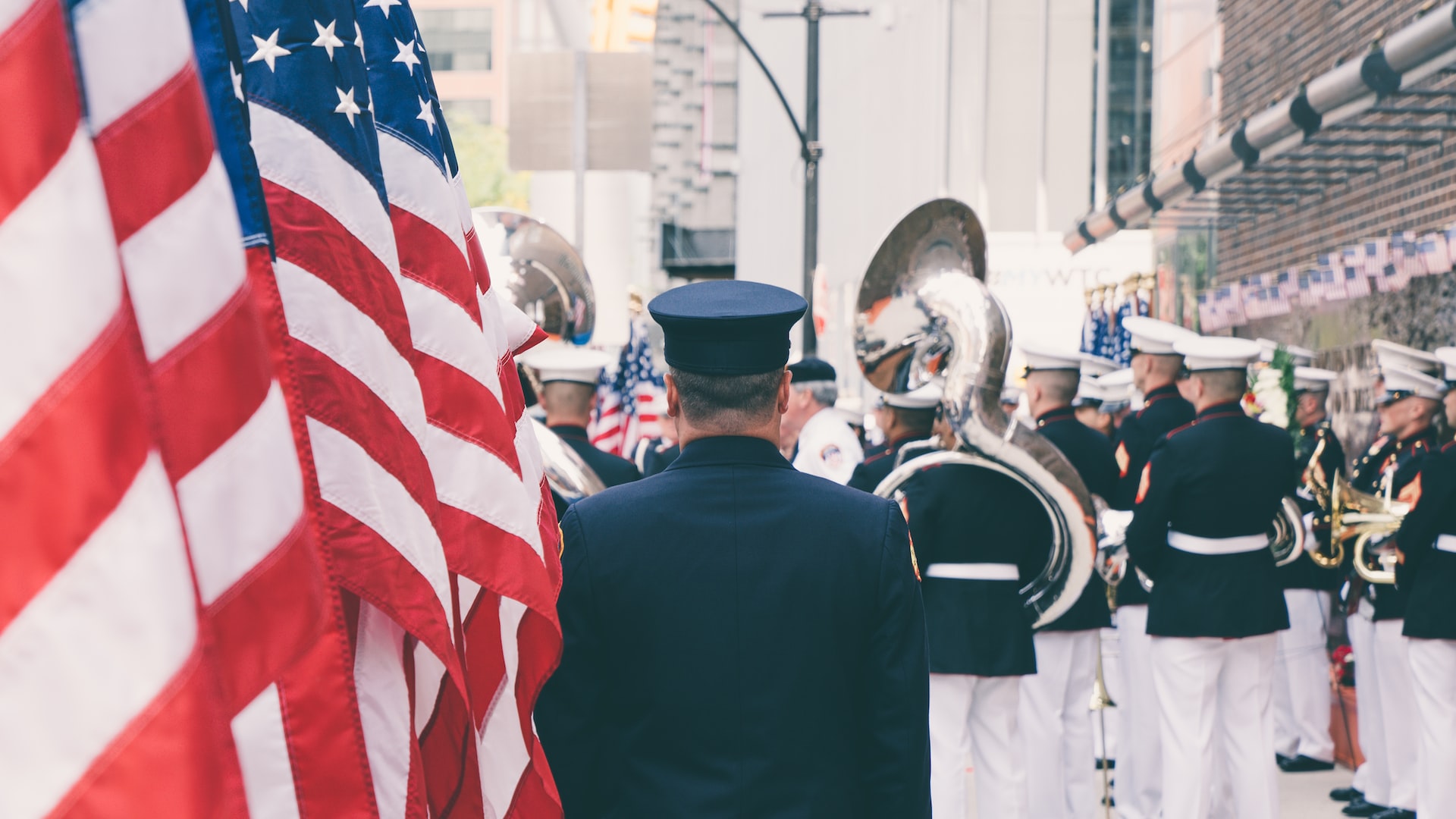 Veteran Near a bunch of flags | Veteran Car Donations