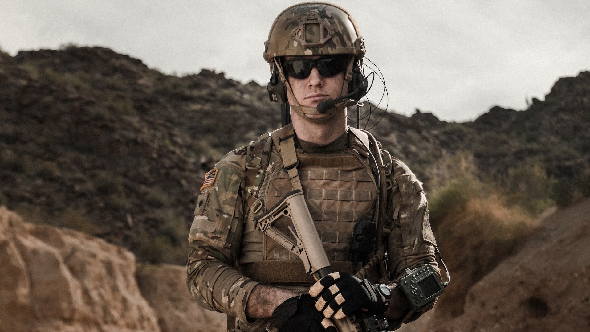 man in brown and black camouflage uniform holding rifle photo | Veteran Car Donations