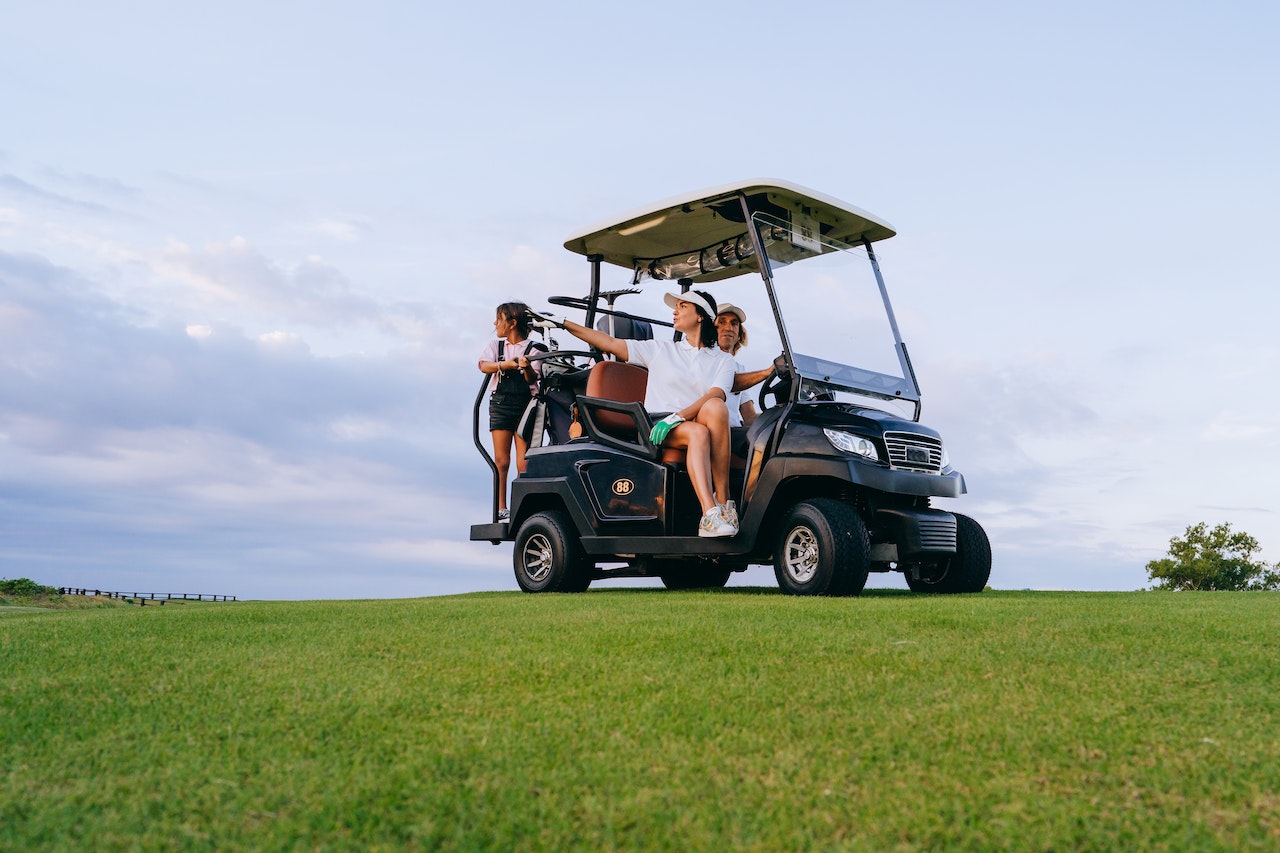 A Family Riding a Golf Cart | Veteran Car Donations