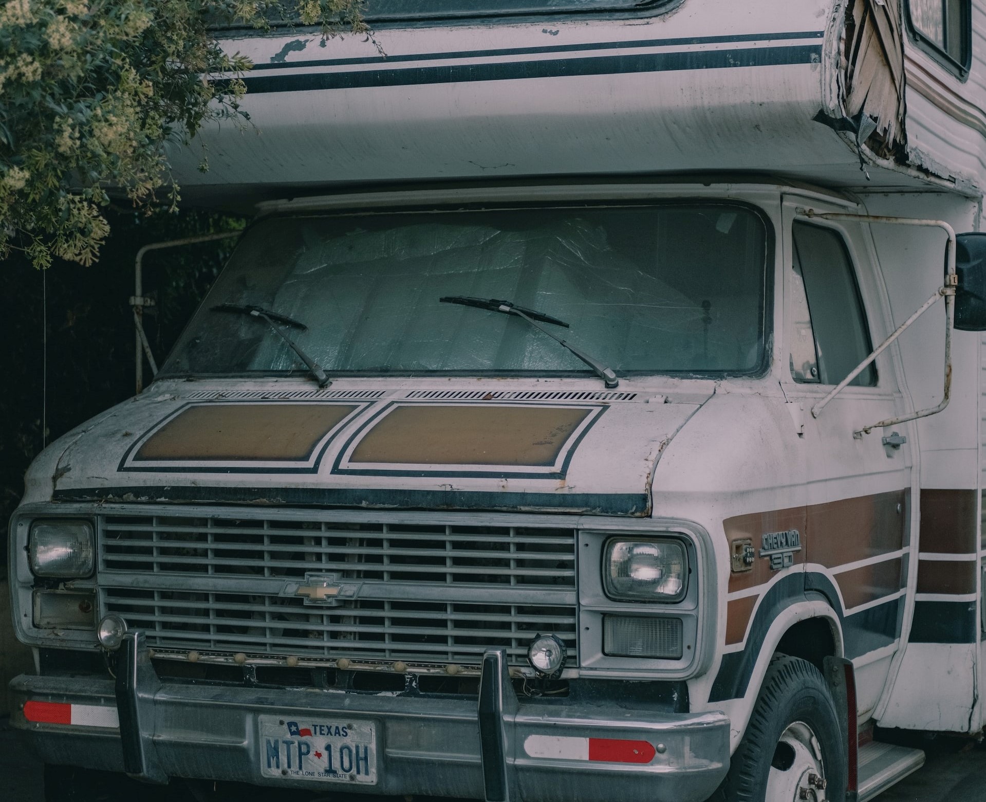 White Rv Parked under the Tree | Veteran Car Donations