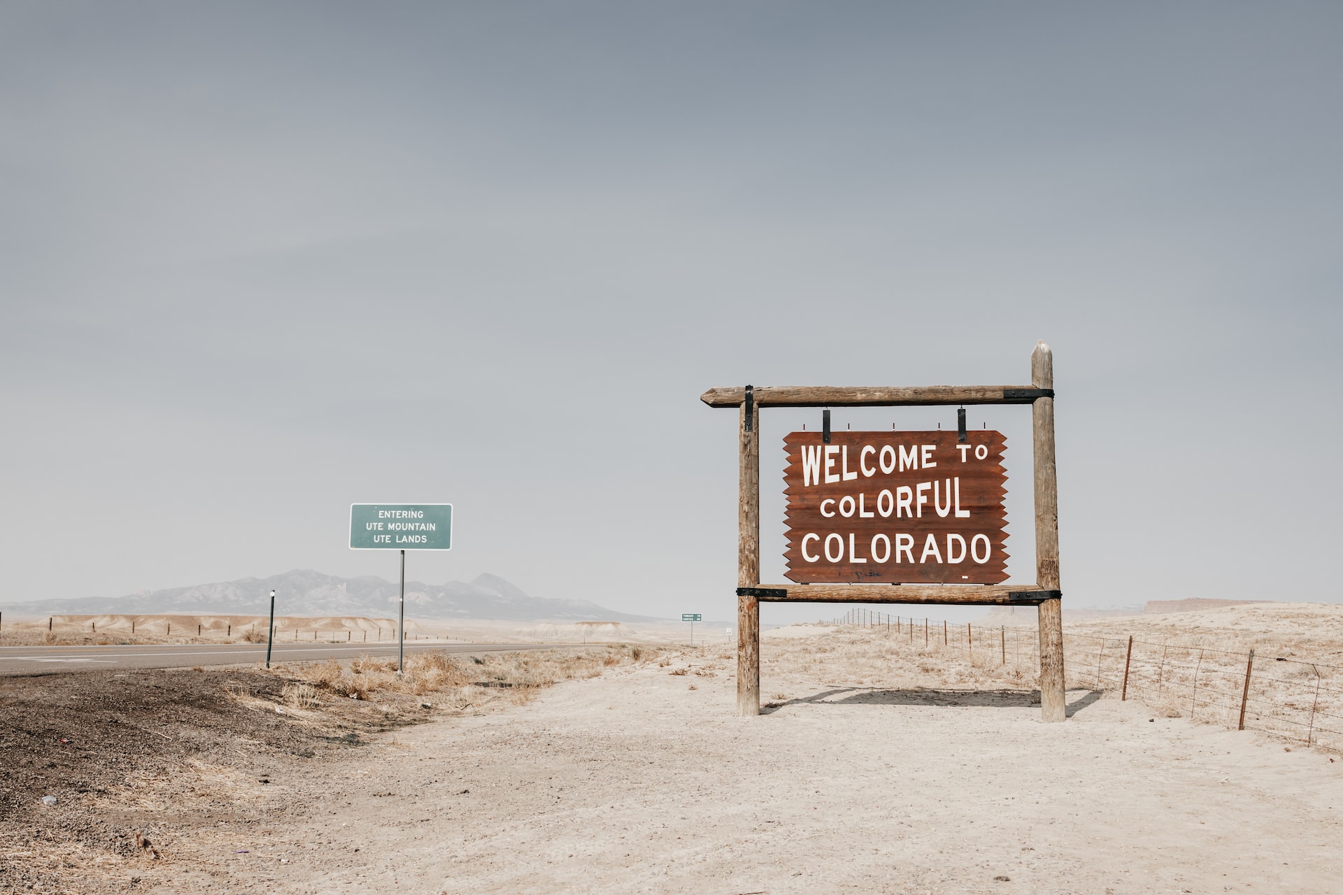 brown wooden signage on brown sand during daytime photo | Veteran Car Donations