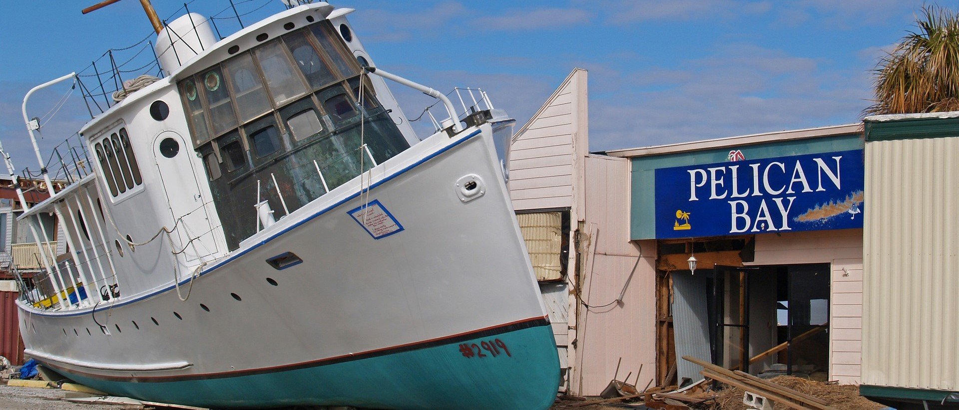 Flood-Damaged Boat in Pelican Bay - VeteranCarDonations.org