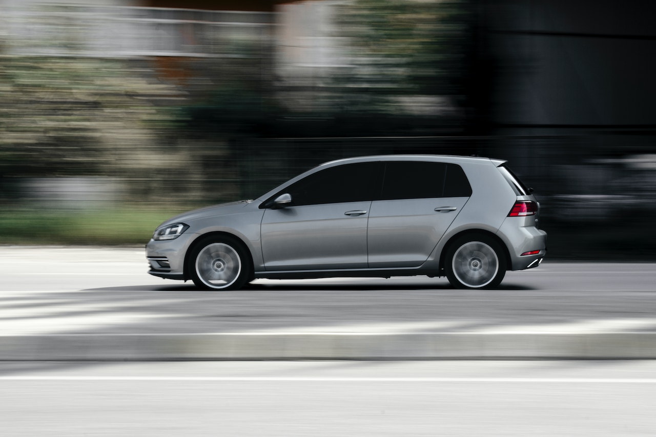 Silver Hatchback Driving Fast on the Road | Veteran Car Donations