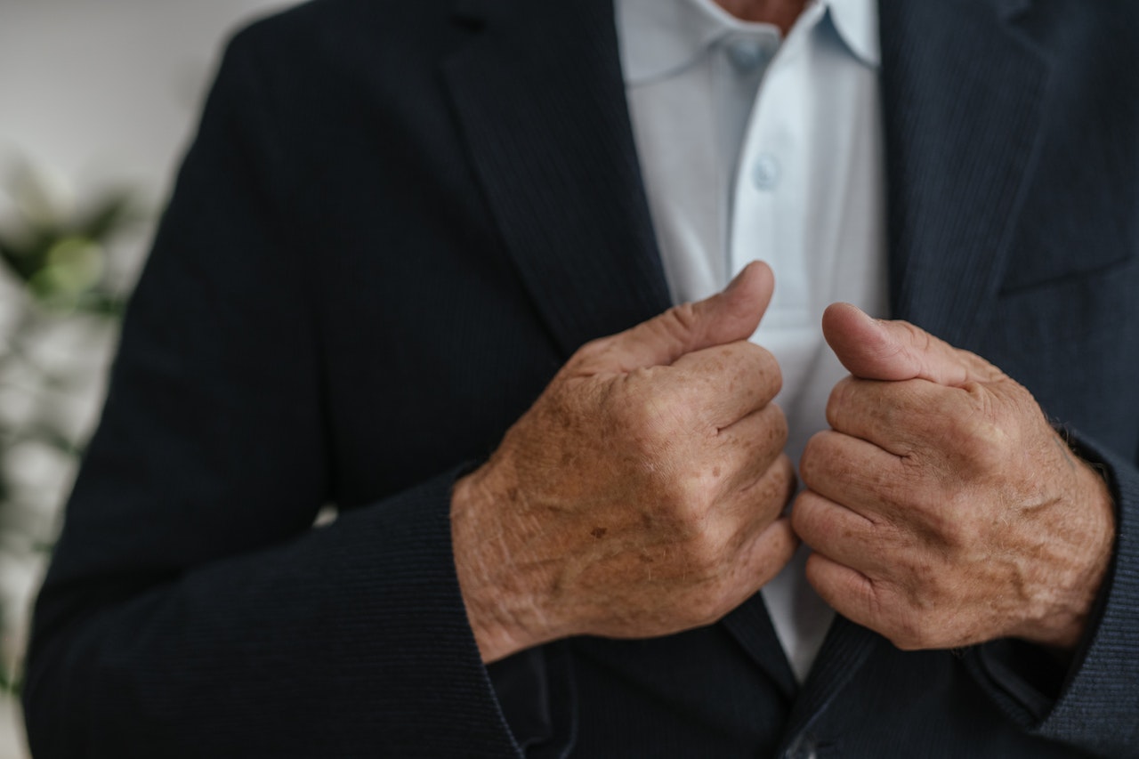 Man Fixing his Suit Jacket | Veteran Car Donations
