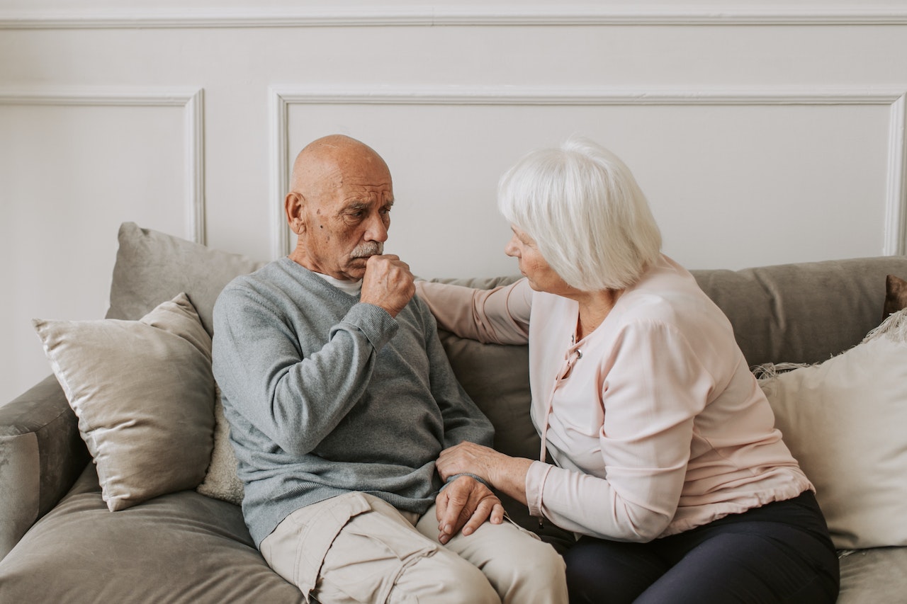 Man in Gray Sweater Sitting Beside Woman | Veteran Car Donations
